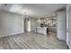 Spacious living room and kitchen area featuring stylish pendant lighting and light wood flooring at 16822 Imperial Ct, Fishers, IN 46040