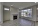 Bright living room with a fireplace, large windows, and light-colored wood flooring at 16822 Imperial Ct, Fishers, IN 46040