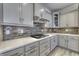 Kitchen area featuring modern appliances and light-gray cabinetry with a gray backsplash at 16822 Imperial Ct, Fishers, IN 46040