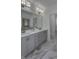 Bright bathroom featuring double sink vanity, decorative lighting, and elegant marble floors at 16822 Imperial Ct, Fishers, IN 46040