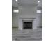 Living room fireplace featuring gray tile detail and mantel; light, hard surface floors at 16822 Imperial Ct, Fishers, IN 46040