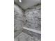 Shower with white marble tile, a built-in seat and mosaic tile flooring at 16822 Imperial Ct, Fishers, IN 46040