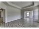 Living room with hardwood floors, white walls, base trim, and windows for natural light at 16822 Imperial Ct, Fishers, IN 46040
