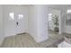Inviting entryway with a stylish front door, light wood floors, and abundant natural light at 16822 Imperial Ct, Fishers, IN 46040