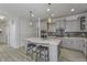 Modern kitchen with gray cabinets, a center island with seating, and stainless steel appliances at 16822 Imperial Ct, Fishers, IN 46040