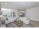 Bright and open living room featuring white sofas, large windows, and access to the backyard at 16822 Imperial Ct, Fishers, IN 46040