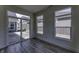 Sun room with wood floors, white walls, and several windows for natural light and access to the patio at 16822 Imperial Ct, Fishers, IN 46040