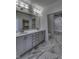 Bathroom with double sinks, modern fixtures, beautiful tile floors and a shower at 16822 Imperial Ct, Fishers, IN 46040