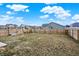Fenced backyard with a swing set and a spacious grassy area, perfect for play and recreation at 1835 Fairmount Dr, Greenfield, IN 46140