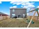 Large backyard with a wooden fence, swing set, and patio perfect for outdoor enjoyment at 1835 Fairmount Dr, Greenfield, IN 46140