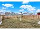 Swing set in a fenced backyard offering ample space for play and outdoor activities at 1835 Fairmount Dr, Greenfield, IN 46140