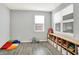 Versatile bonus room with gray walls, wood-look floors, and large windows for natural light and playful decor at 1835 Fairmount Dr, Greenfield, IN 46140