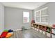 Versatile bonus room with gray walls, wood-look floors, and large windows for natural light and playful decor at 1835 Fairmount Dr, Greenfield, IN 46140