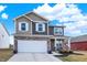 Charming two-story home with a stone-accented facade, two-car garage, and well-manicured landscaping at 1835 Fairmount Dr, Greenfield, IN 46140