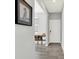 Welcoming hallway with light gray walls, wood-look floors, and decorative shelf with white bins for storage at 1835 Fairmount Dr, Greenfield, IN 46140
