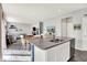 Bright kitchen featuring an island with granite countertops and a sink, and an open view to the living room at 1835 Fairmount Dr, Greenfield, IN 46140