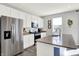Updated kitchen boasts stainless steel appliances, white cabinets, and an island with a breakfast bar at 1835 Fairmount Dr, Greenfield, IN 46140