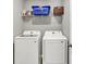 Convenient laundry room featuring a washer, dryer, and overhead storage shelf for an organized space at 1835 Fairmount Dr, Greenfield, IN 46140