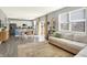 Open-concept living room flowing into the kitchen, with gray walls, sofa, table, and wood-look floors at 1835 Fairmount Dr, Greenfield, IN 46140