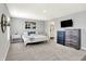 Main bedroom with neutral tones, carpet, and a view of the ensuite bathroom at 1835 Fairmount Dr, Greenfield, IN 46140
