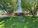 Charming brick home with well-maintained lawn, mature trees and flowerbeds enhancing the curb appeal at 2130 Theobald St, Shelbyville, IN 46176