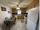 Charming eat-in kitchen features oak cabinets, tile floors, and a ceiling fan with a light fixture at 2130 Theobald St, Shelbyville, IN 46176