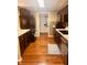 Galley-style kitchen with stainless steel appliances, wood floors, and an open pass-through to another room at 2317 Lincoln Dr, Cicero, IN 46034