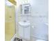 Tiled bathroom featuring a stand up shower, white sink vanity, and built in cabinet at 2613 E 7Th St, Anderson, IN 46012