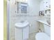 Traditional bathroom featuring a white sink vanity, tiled walls, and a toilet at 2613 E 7Th St, Anderson, IN 46012
