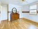 Bright bedroom features hardwood floors, neutral walls, and a classic wooden dresser and mirror at 2613 E 7Th St, Anderson, IN 46012