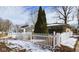 Charming brick home with a white picket fence and winter landscaping at 2613 E 7Th St, Anderson, IN 46012