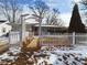 Charming home with a white picket fence, winter landscaping, and a paved walkway at 2613 E 7Th St, Anderson, IN 46012