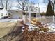 Charming single-story home featuring a decorative white pergola and attached garage at 2613 E 7Th St, Anderson, IN 46012