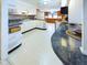 Bright kitchen with white cabinets, granite countertops, and stainless steel appliances at 2613 E 7Th St, Anderson, IN 46012