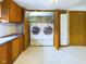 Laundry room with washer, dryer, and open shelving at 2613 E 7Th St, Anderson, IN 46012