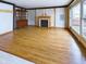 Spacious living room with hardwood floors, fireplace, and large picture windows at 2613 E 7Th St, Anderson, IN 46012