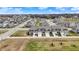 An aerial photograph displaying a residential area with a row of gray townhomes, lawns, and parking spaces available at 2792 Maricopa Blvd, Whitestown, IN 46075