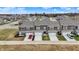 A close aerial shot of newly constructed townhouses with grey exteriors, white trim, individual garages, and driveways at 2792 Maricopa Blvd, Whitestown, IN 46075