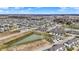 A captivating aerial shot of a residential area, complete with cozy homes, a scenic pond, and abundant green space at 2792 Maricopa Blvd, Whitestown, IN 46075