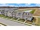 Aerial view of newly constructed townhomes with a scenic pond nearby at 2792 Maricopa Blvd, Whitestown, IN 46075