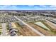 A stunning aerial view of a planned community boasting modern residences, a peaceful pond, and vast stretches of greenery at 2792 Maricopa Blvd, Whitestown, IN 46075