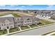 Aerial shot showcases new townhomes near a scenic pond with blue skies above at 2792 Maricopa Blvd, Whitestown, IN 46075