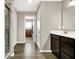 This bathroom has a shower, a sink with dark cabinets and modern lighting at 2792 Maricopa Blvd, Whitestown, IN 46075