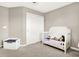 ' bedroom featuring a crib, a toy box, carpet flooring, and closet doors at 2792 Maricopa Blvd, Whitestown, IN 46075