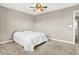 Neutral bedroom with a ceiling fan, carpet flooring, a gray bedspread, and a doorway at 2792 Maricopa Blvd, Whitestown, IN 46075
