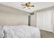 Neutral bedroom featuring a ceiling fan, carpet flooring, a gray bedspread, and closet doors at 2792 Maricopa Blvd, Whitestown, IN 46075