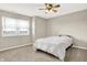Bedroom features a ceiling fan, a large window, and neutral carpeting at 2792 Maricopa Blvd, Whitestown, IN 46075