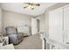 ' bedroom featuring a crib, a rocking chair, carpet flooring, closet doors, and a ceiling fan at 2792 Maricopa Blvd, Whitestown, IN 46075