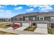 New townhome construction featuring attached garages, neutral siding, brick accents, and sidewalks at 2792 Maricopa Blvd, Whitestown, IN 46075