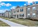Attractive townhome showcases brick, manicured landscaping, dormer windows, and sidewalk at 2792 Maricopa Blvd, Whitestown, IN 46075